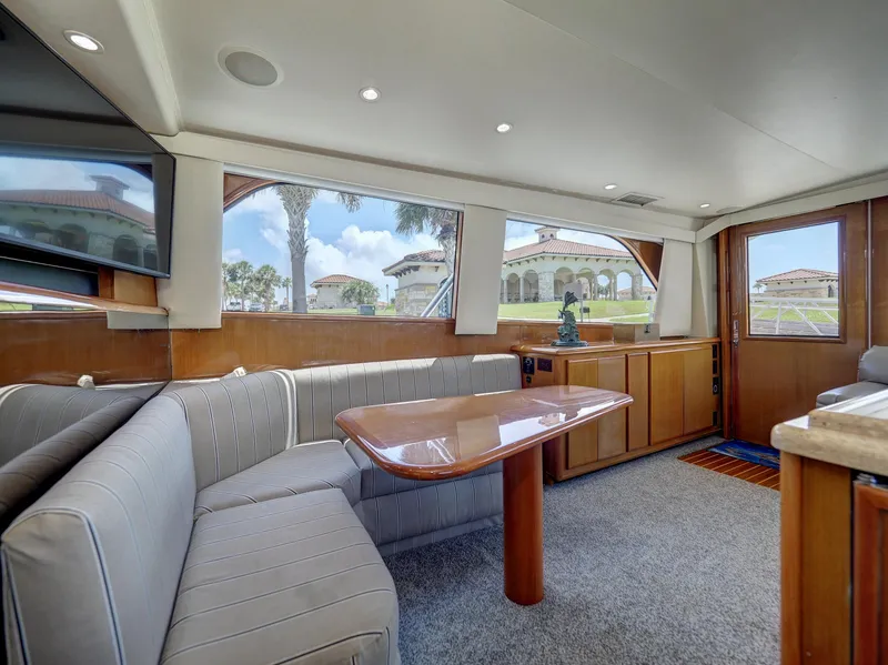 Slide: The Image of Interior of 2001 Viking Convertible yacht with elegant seating and panoramic windows. - 9