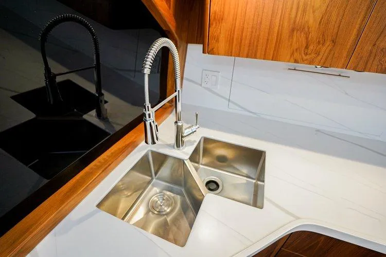 Slide: The Image of Modern kitchen sink with stainless steel fixtures on Matthews 62 Sport Fish yacht, 2024 model. - 11
