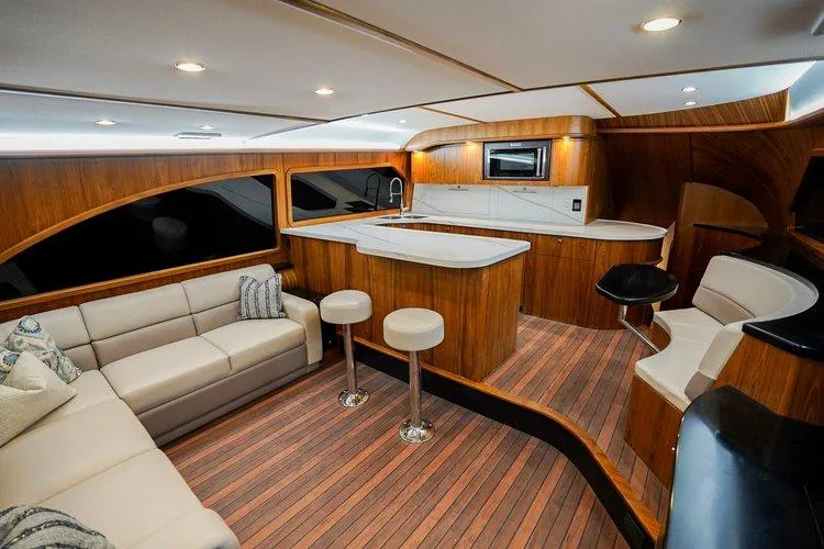 Slide: The Image of Luxurious interior of 2024 Matthews 62 Sport Fish yacht with modern kitchen and seating area. - 12