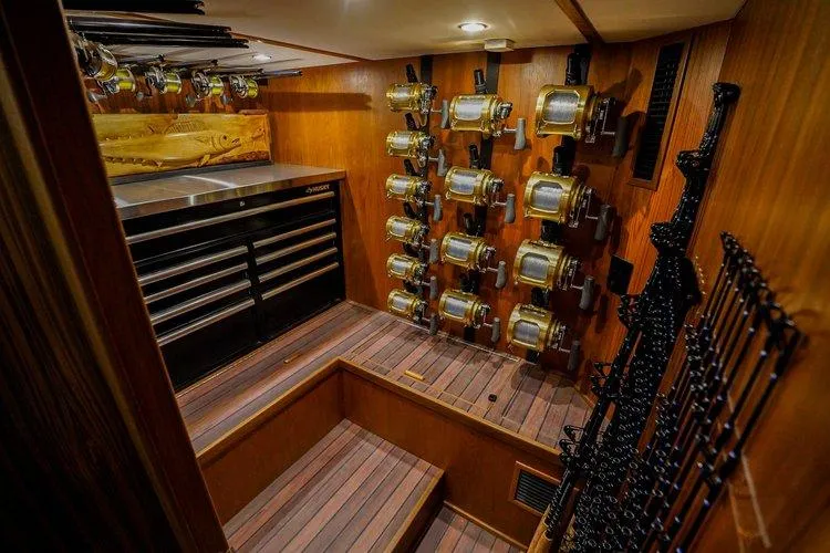 Slide: The Image of Fishing equipment storage on 2024 Matthews 62 Sport Fish yacht, featuring reels and rods. - 16