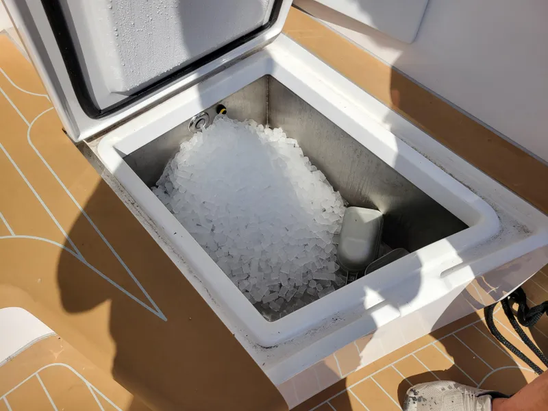 Slide: The Image of Ice-filled compartment on 2024 Matthews 62 Sport Fish boat deck. - 28