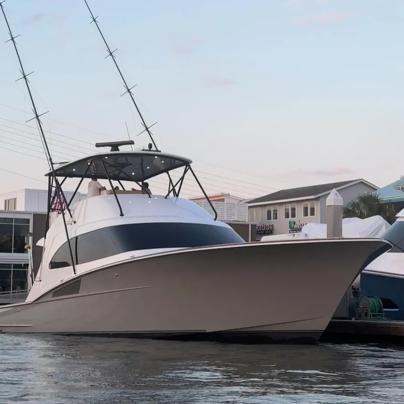 Slide: The Image of 2024 Matthews 62 Sport Fish yacht docked at marina, showcasing sleek design and fishing equipment. - 31