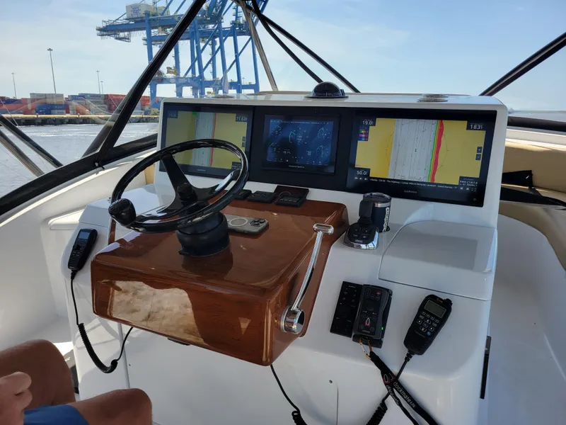 Slide: The Image of 2024 Matthews 62 Sport Fish helm with advanced navigation displays and controls. - 5