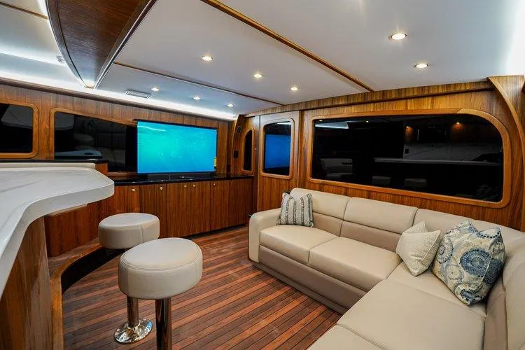 Slide: The Image of Luxurious interior of 2024 Matthews 62 Sport Fish yacht with modern seating and wood finishes. - 6