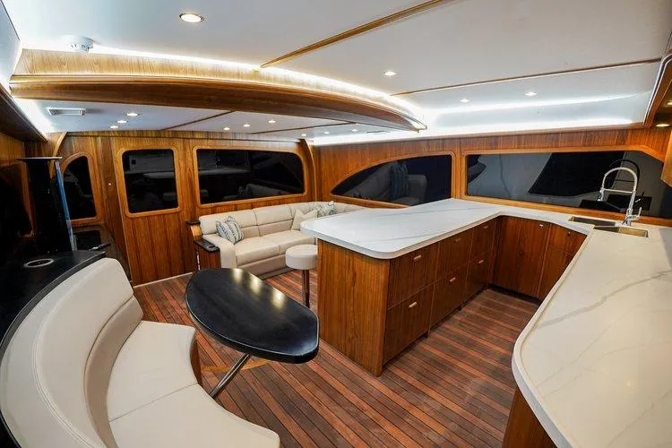 Slide: The Image of Luxurious interior of 2024 Matthews 62 Sport Fish yacht with modern wood finishes. - 7
