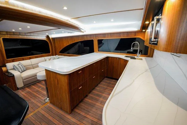 Slide: The Image of Luxurious interior of 2024 Matthews 62 Sport Fish yacht with modern kitchen and seating area. - 8