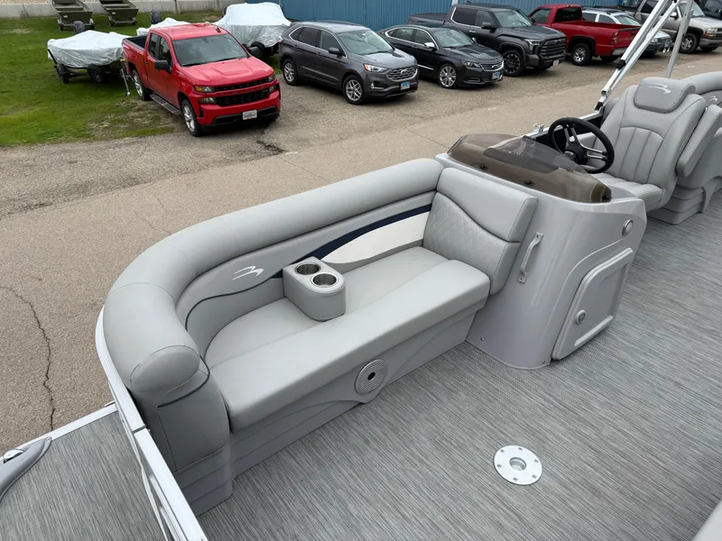 Slide: The Image of 2021 Bennington 22 SSR pontoon boat interior with gray seating and steering console. - 10