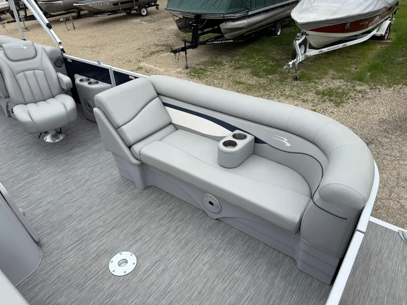 Slide: The Image of 2021 Bennington 22 SSR pontoon boat interior with gray seating and cup holders. - 11