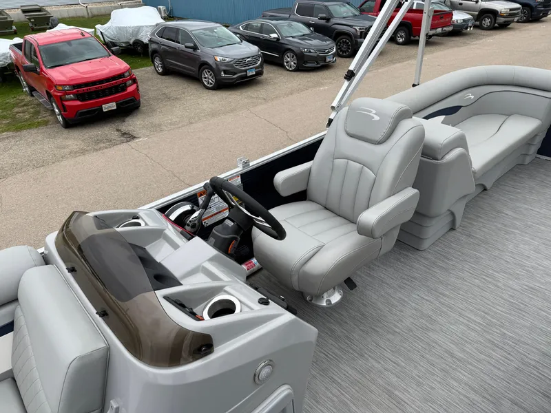 Slide: The Image of 2021 Bennington 22 SSR pontoon boat interior with gray seating and steering console. - 13