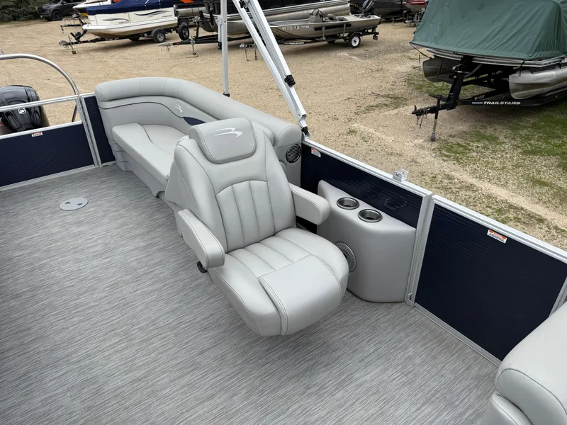 Slide: The Image of 2021 Bennington 22 SSR pontoon boat interior with plush seating and cup holders. - 14