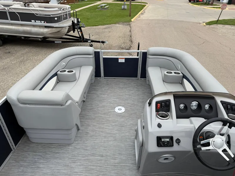 Slide: The Image of 2021 Bennington 22 SSR pontoon boat interior with gray seating and modern dashboard. - 15