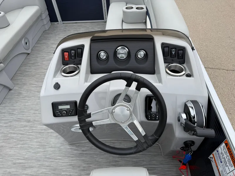 Slide: The Image of 2021 Bennington 22 SSR boat dashboard with steering wheel and control panel. - 16