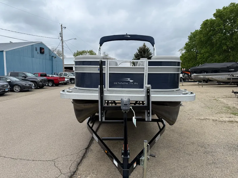 Slide: The Image of 2021 Bennington 22 SSR pontoon boat on trailer, parked outdoors. - 2