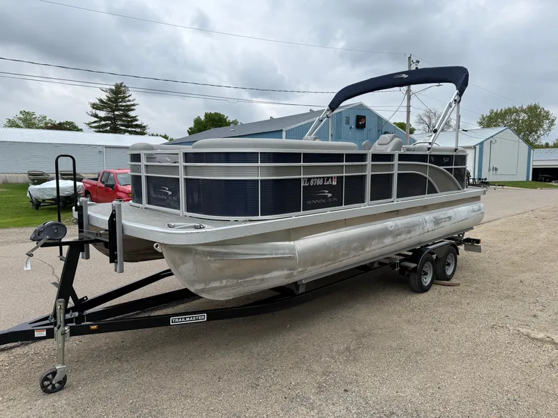 Slide: The Image of 2021 Bennington 22 SSR pontoon boat on trailer, parked outdoors. - 3