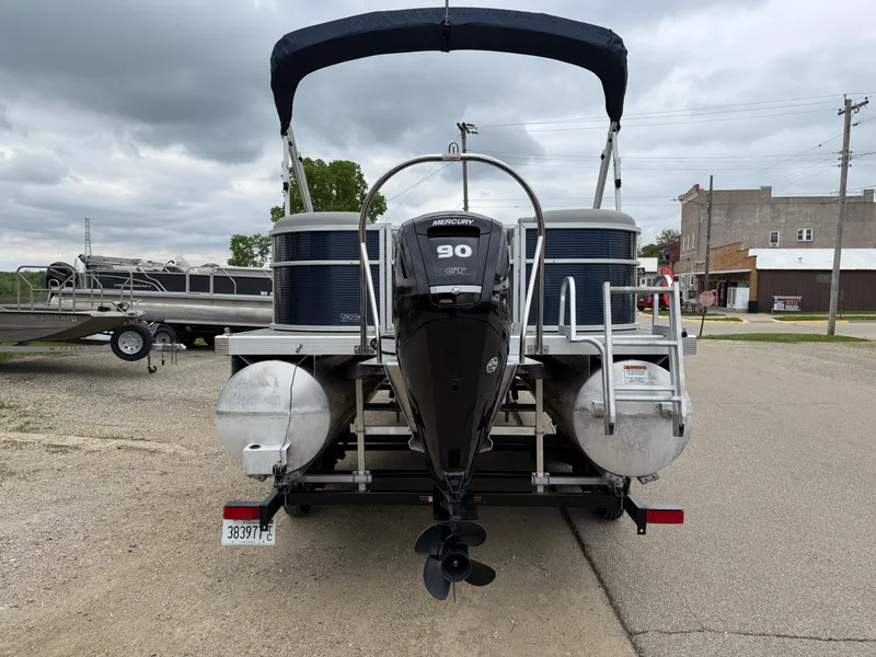 Slide: The Image of 2021 Bennington 22 SSR pontoon boat with a 90 HP motor, parked on a trailer. - 6