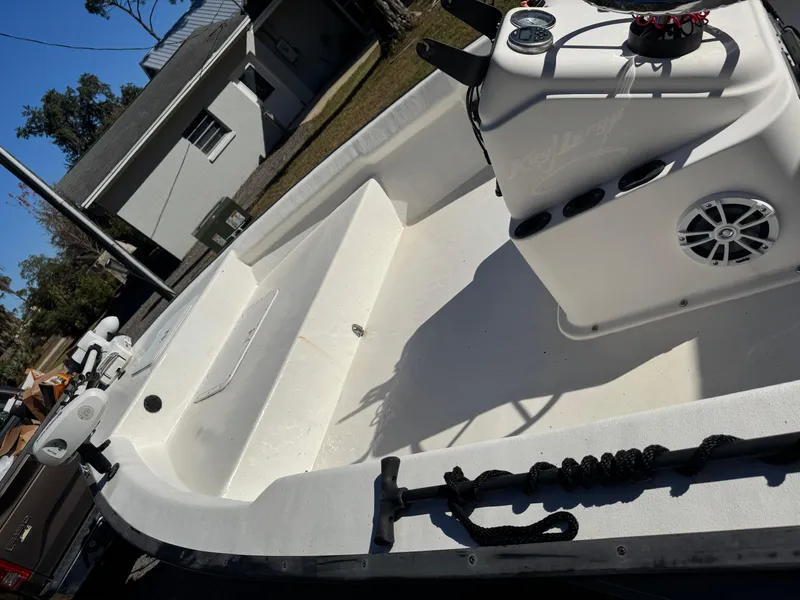 Slide: The Image of 2006 Key Largo 174 boat interior with seating and console, parked outdoors. - 3