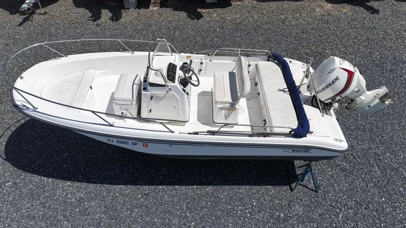 Slide: The Image of 2001 Boston Whaler DAUNTLESS boat with Evinrude outboard motor, viewed from above on gravel. - 1