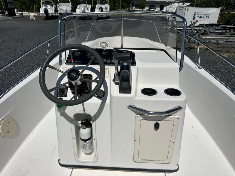Slide: The Image of 2001 Boston Whaler DAUNTLESS boat console with steering wheel and controls. - 13