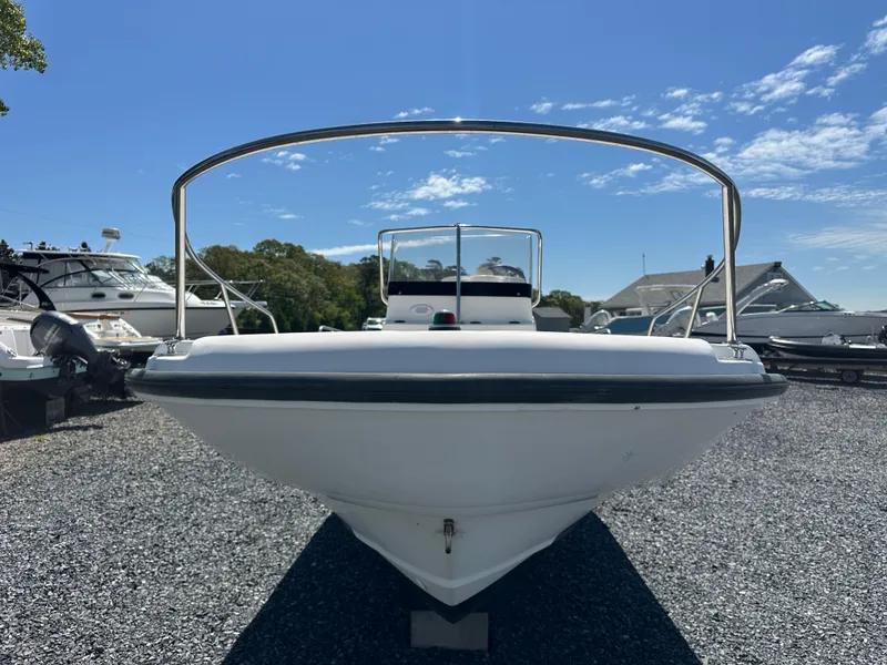 Slide: The Image of 2001 Boston Whaler DAUNTLESS boat on gravel lot under clear blue sky. - 17