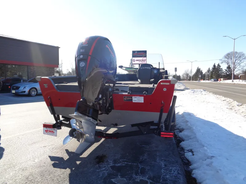 Slide: The Image of 2025 Lund 1875 Impact XS SS boat on snowy roadside, rear view. - 17
