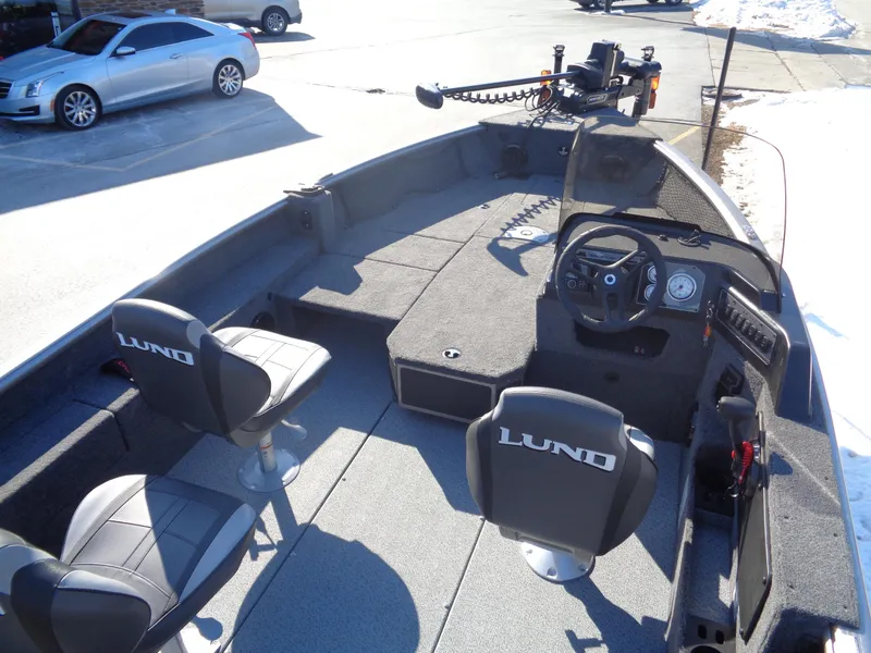 Slide: The Image of 2025 Lund 1875 Impact XS SS boat interior with seating and steering console. - 19