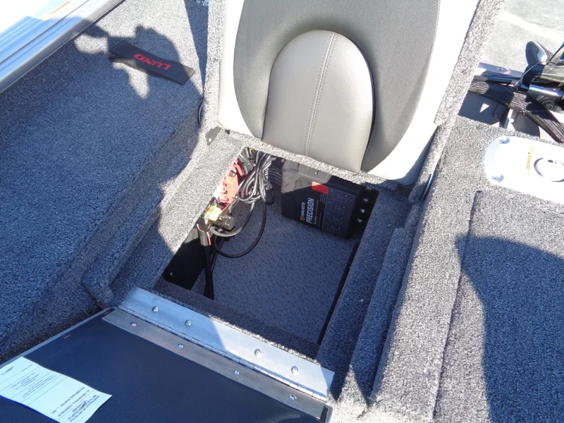 Slide: The Image of 2025 Lund 1875 Impact XS SS boat interior showing storage compartment and wiring. - 21