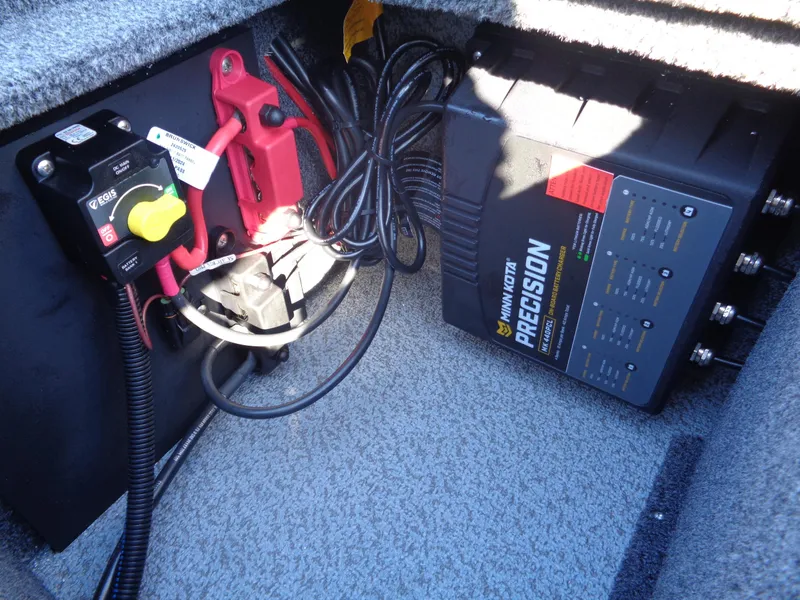 Slide: The Image of 2025 Lund 1875 Impact XS SS boat battery compartment with Minn Kota Precision charger. - 22