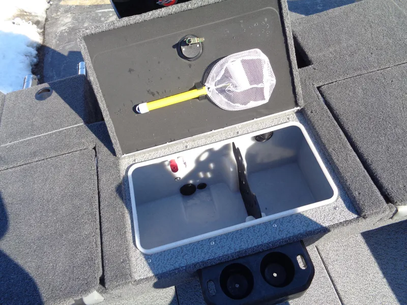 Slide: The Image of 2025 Lund 1875 Impact XS SS boat storage compartment with fishing net and cup holders. - 23