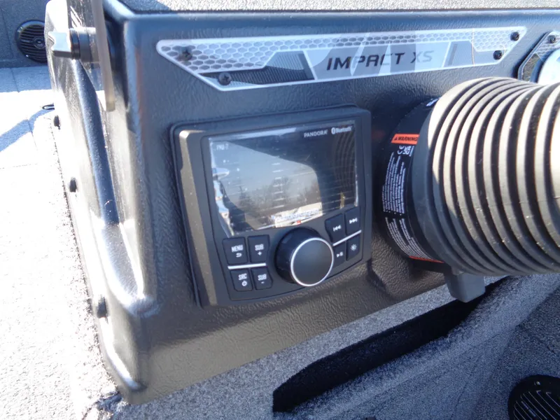 Slide: The Image of Control panel of 2025 Lund 1875 Impact XS SS boat, featuring navigation and audio controls. - 29
