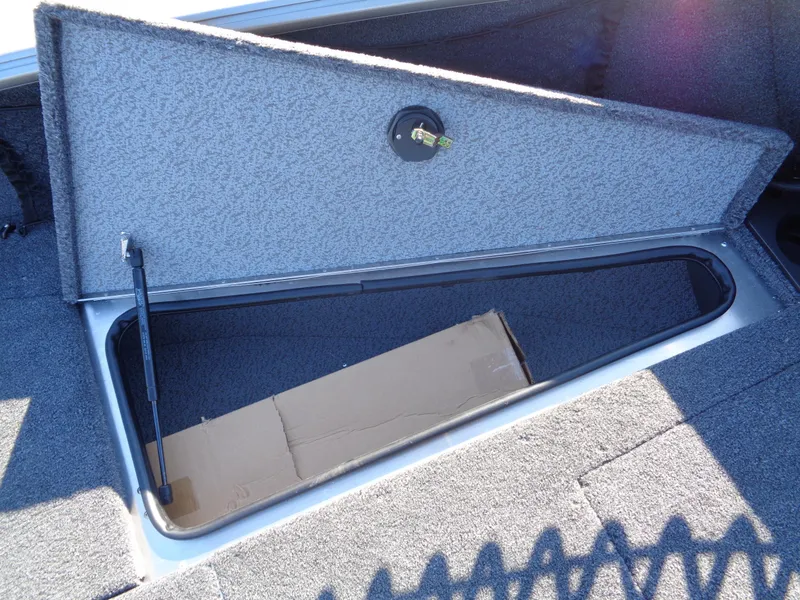 Slide: The Image of Storage compartment in 2025 Lund 1875 Impact XS SS boat, open with cardboard inside. - 33
