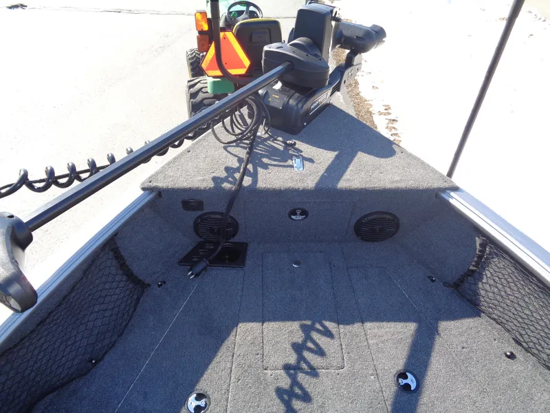 Slide: The Image of 2025 Lund 1875 Impact XS SS boat interior with trolling motor and carpeted deck. - 35