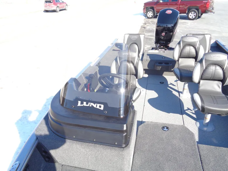 Slide: The Image of 2025 Lund 1875 Impact XS SS boat interior with seating and steering console. - 36
