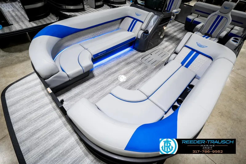 Slide: The Image of 2025 Bennington 24 MSB pontoon boat interior with blue LED lighting and plush seating. - 12