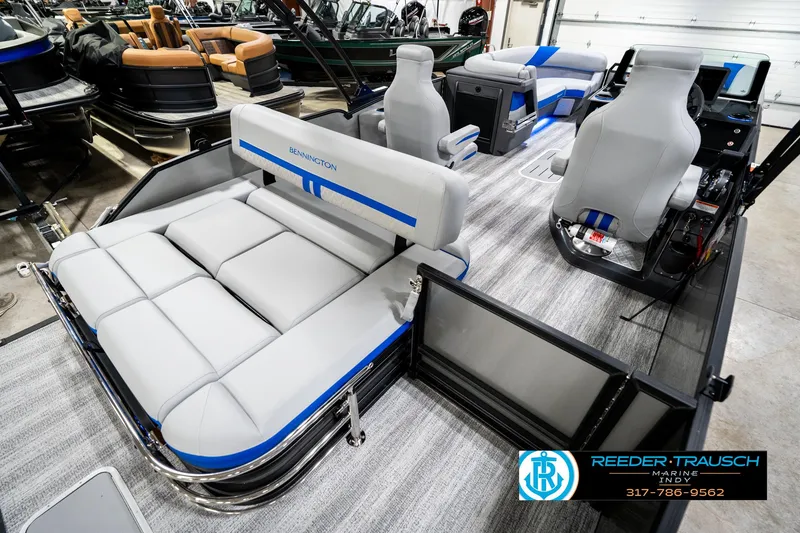 Slide: The Image of 2025 Bennington 24 MSB pontoon boat interior with gray seating and blue accents. - 14