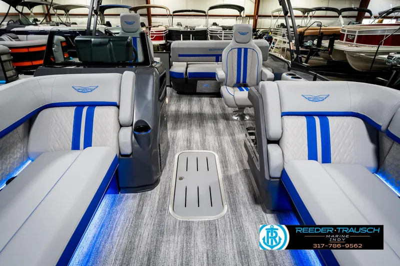 Slide: The Image of 2025 Bennington 24 MSB pontoon boat interior with blue-accented seating and modern design. - 16