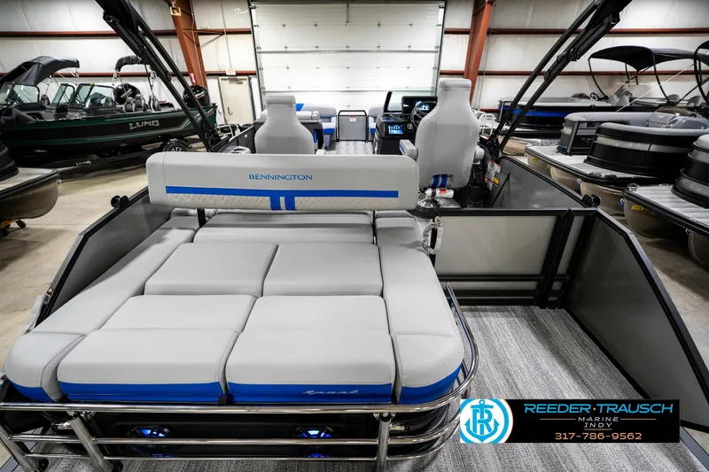 Slide: The Image of 2025 Bennington 24 MSB pontoon boat interior with plush seating in showroom. - 19