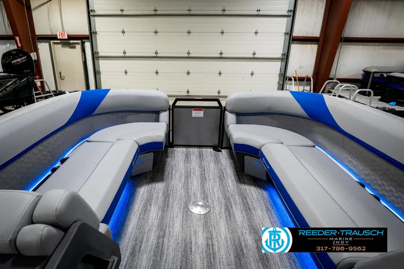 Slide: The Image of 2025 Bennington 24 MSB pontoon boat interior with modern seating and blue LED lighting. - 21