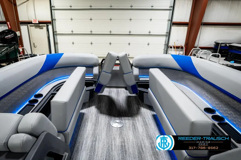 Slide: The Image of 2025 Bennington 24 MSB pontoon boat interior with modern seating and blue accents. - 22