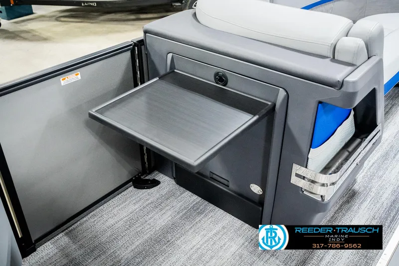 Slide: The Image of 2025 Bennington 24 MSB boat interior with fold-out table and seating. - 25