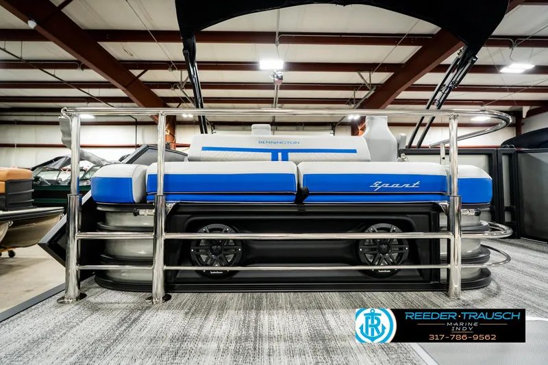 Slide: The Image of 2025 Bennington 24 MSB pontoon boat with blue seating in a showroom. - 33
