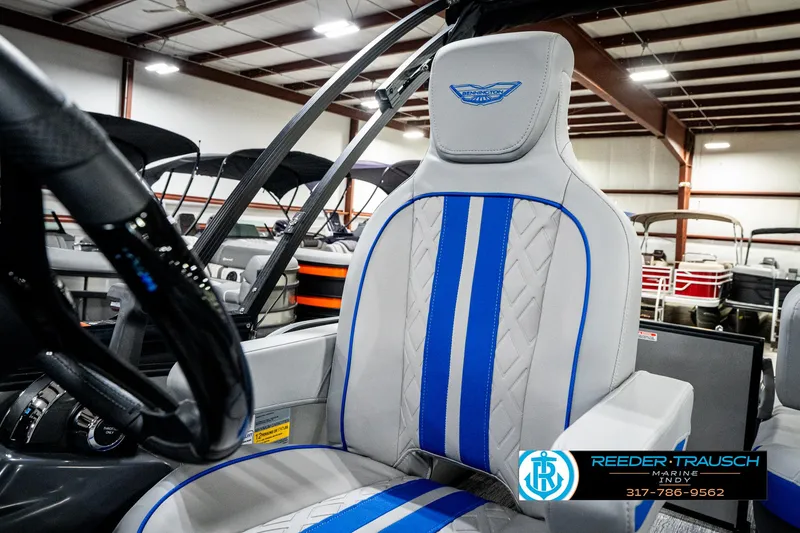 Slide: The Image of 2025 Bennington 24 MSB boat seat with blue accents in showroom. - 42