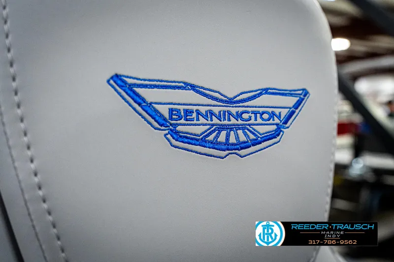 Slide: The Image of 2025 Bennington 24 MSB logo on white upholstery, featuring blue embroidery. - 43