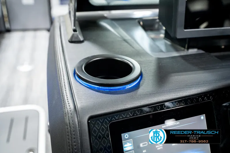 Slide: The Image of 2025 Bennington 24 MSB boat interior with illuminated cup holder and control panel. - 45