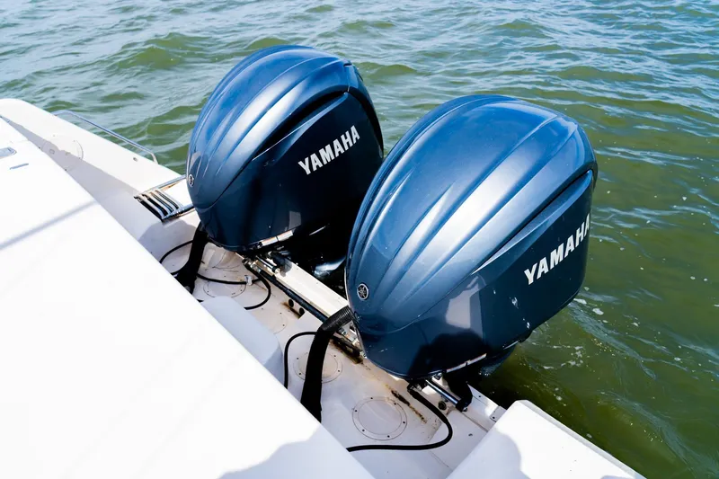 Slide: The Image of Twin Yamaha outboard engines on a 2015 Grady-White 330 Express boat in water. - 10