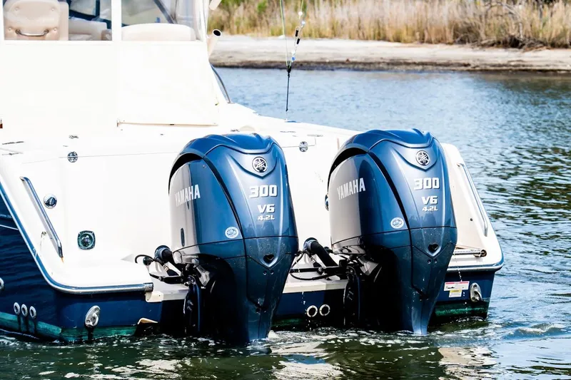 Slide: The Image of 2015 Grady-White 330 Express with twin Yamaha 300 V6 outboard engines in water. - 3