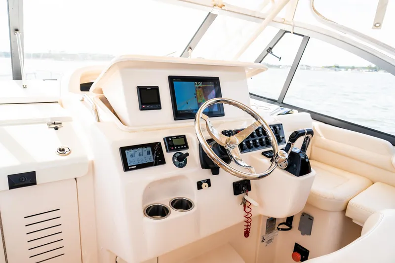 Slide: The Image of 2015 Grady-White 330 Express boat helm with modern controls and navigation system. - 6