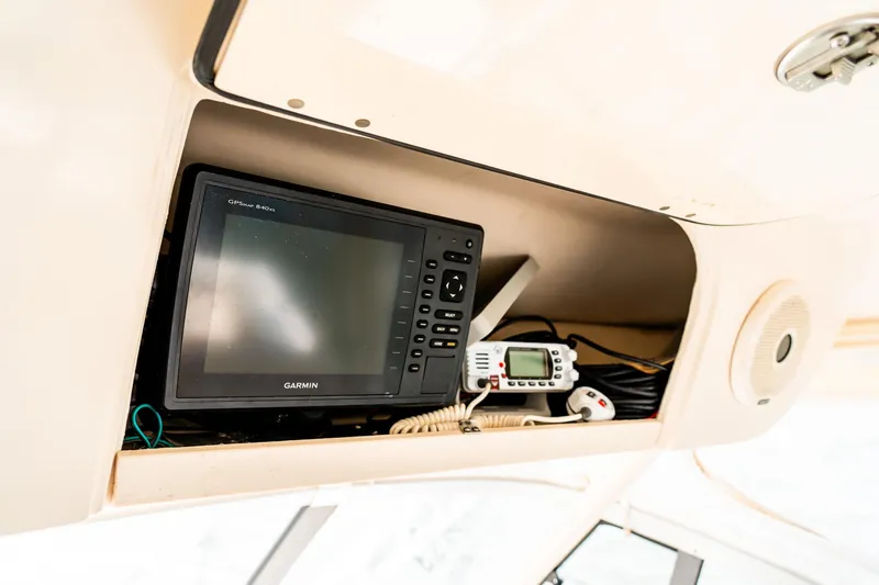 Slide: The Image of 2015 Grady-White 330 Express boat electronics, featuring Garmin display and communication devices. - 7