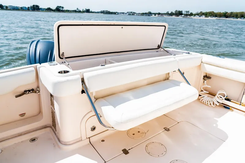 Slide: The Image of 2015 Grady-White 330 Express boat with open storage compartment on deck, near water. - 9