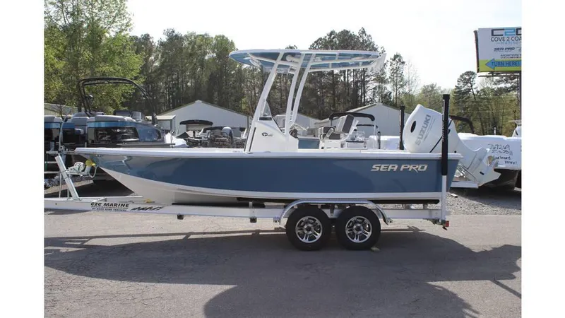 Slide: The Image of 2025 Sea Pro 210 boat on trailer, blue and white design, parked outdoors. - 3