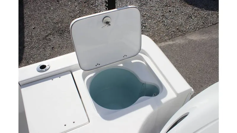 Slide: The Image of Open storage compartment on a 2025 Sea Pro 210 boat, featuring a built-in livewell. - 4